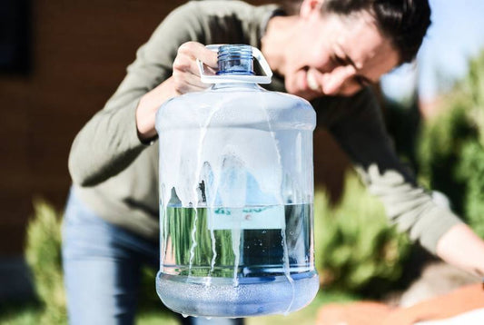 soapy 5 gallon water jug that is being cleaned
