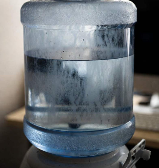 cloudy and dirty 5 gallon water jug from hard water build up