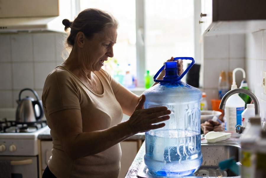 lady cleaning a water cooler jug used for water dispensers